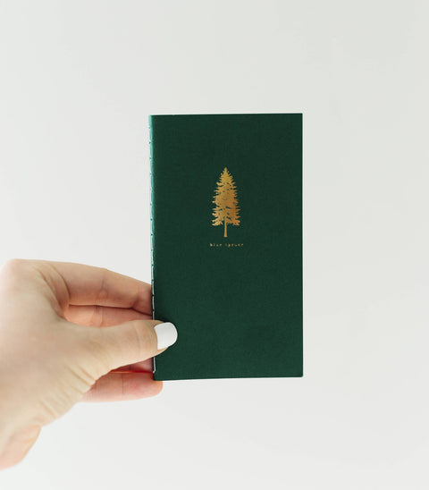 Pocket-sized saddle stitch notebook with pine tree cover by Loblolly Press, featuring a simple, portable design for note-taking.