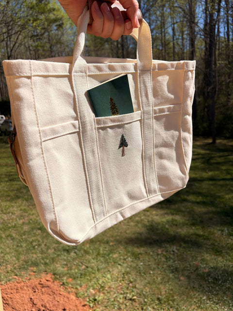 Loblolly Press canvas tote bag with natural beige color and sturdy handles, perfect for carrying books and daily essentials.